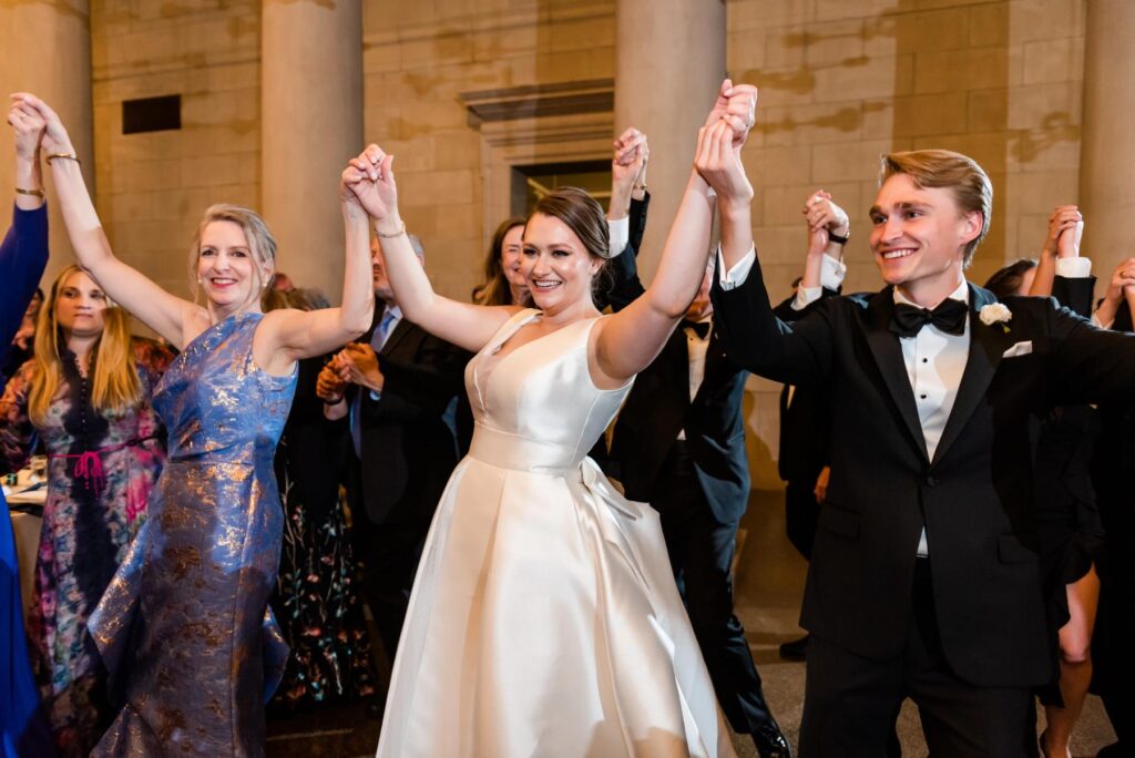 The bride dancing with guests at a Baltimore Museum of Art Wedding reception planned by Blue Sapphire Events.