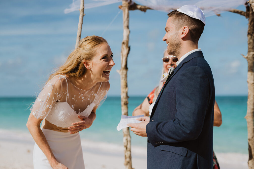 Bahamas Wedding Planner - Blue Sapphire Events for a destination wedding shares images of the beautiful bride and groom laughing at their wedding ceremony.