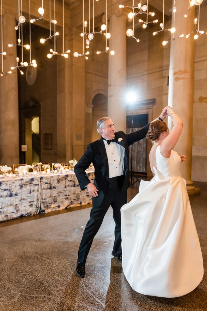 A bride and her father dance at a Baltimore Museum of Art Wedding planned by Blue Sapphire Events.