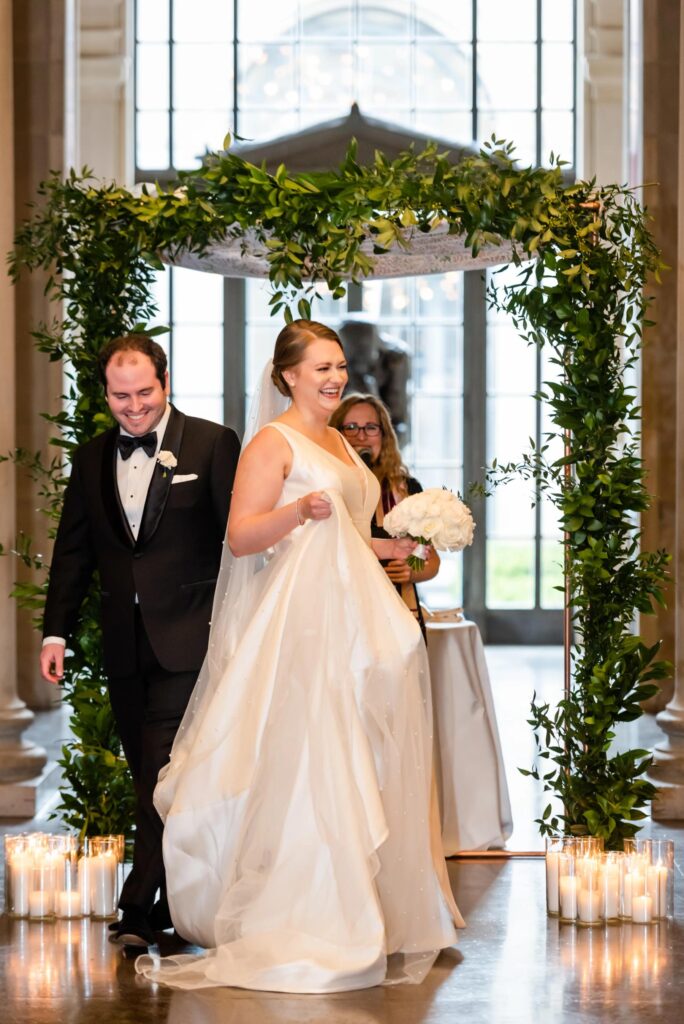 A newly married bride and groom at their wedding ceremony at a Baltimore Museum of Art Wedding planned by Blue Sapphire Events.
