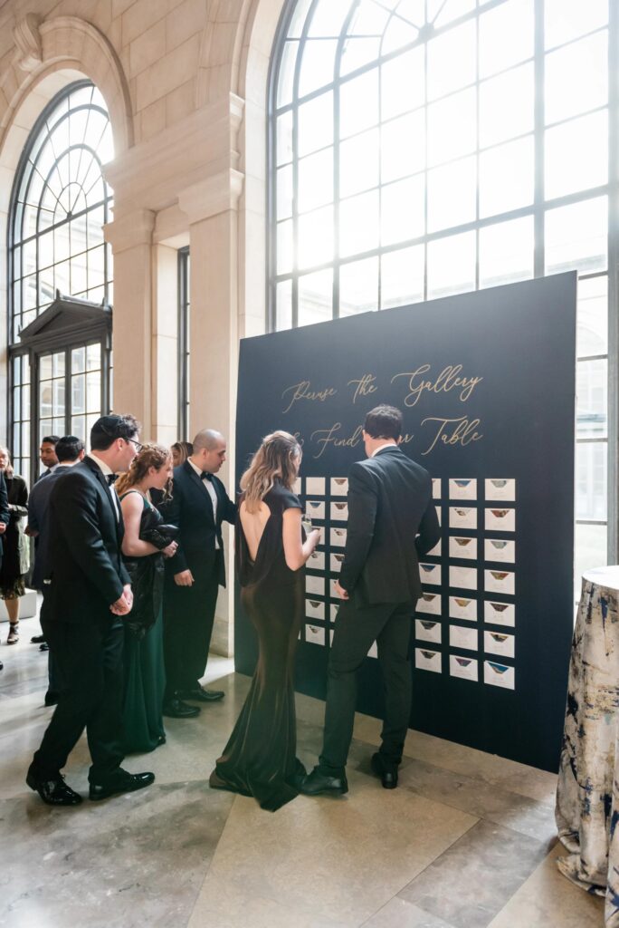 A seating chart is displayed at a Baltimore Museum of Art Wedding planned by Blue Sapphire Events.
